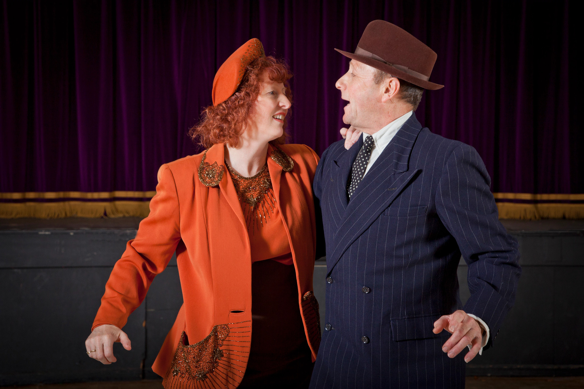 Older couple dancing in auditorium