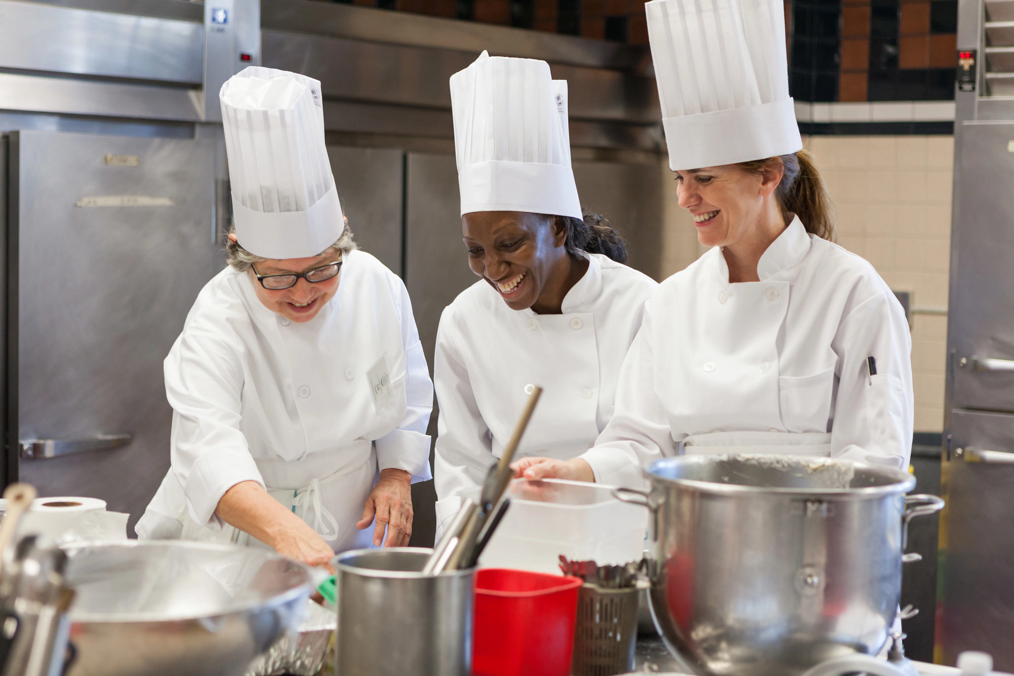 women smiling during a cooking class