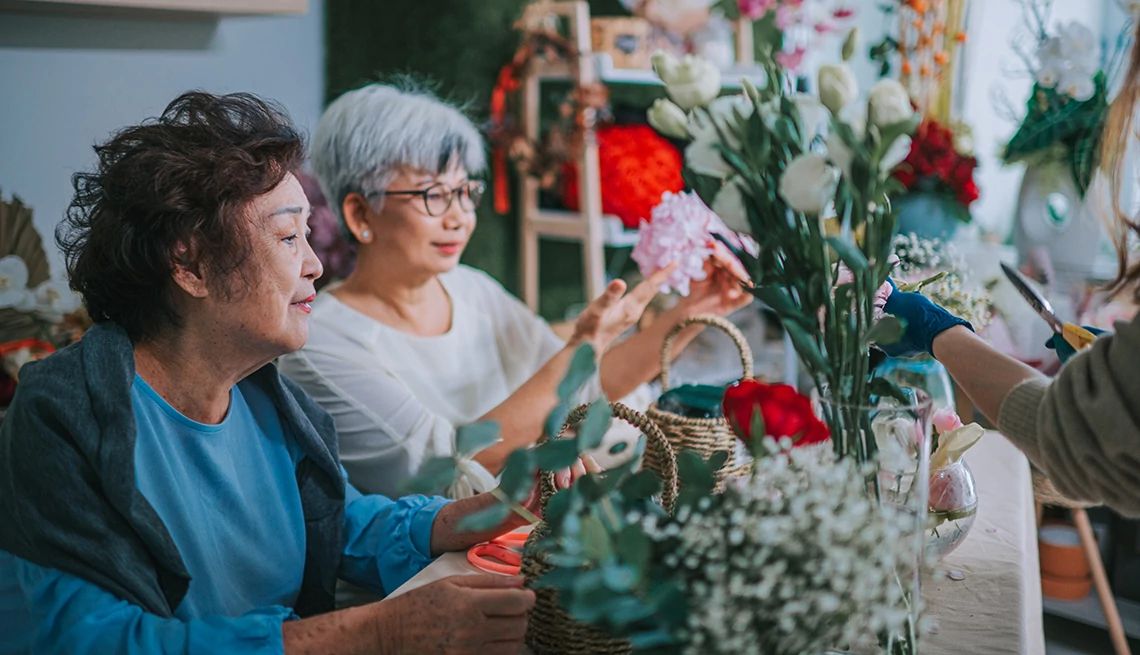 Creating a beautiful bouquet can do more than tickle your senses Two women flower arranging inside of a flower shop