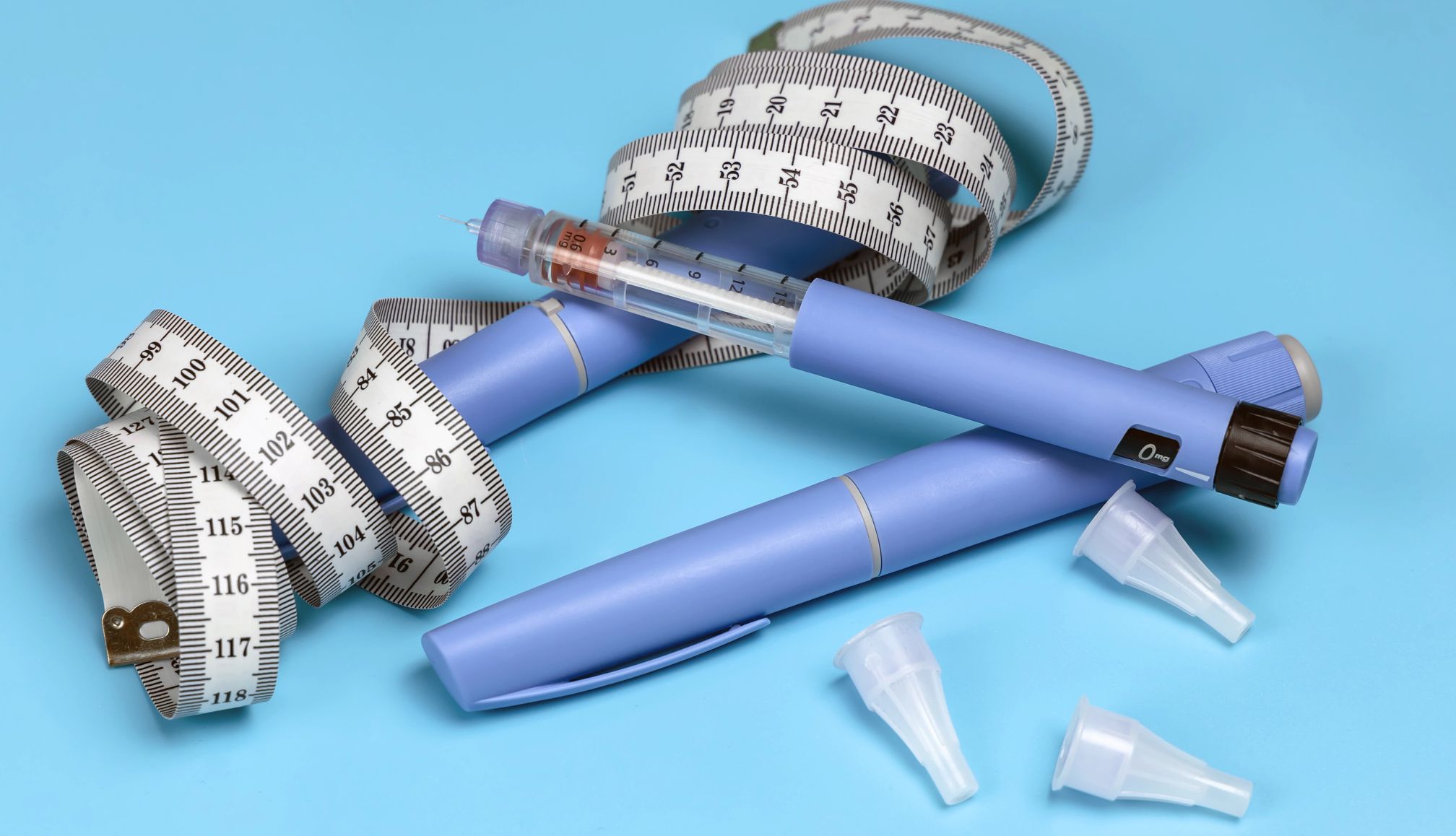 Medicare Weight Loss Drugs Coverage weight loss drugs and a tailors tape on blue background