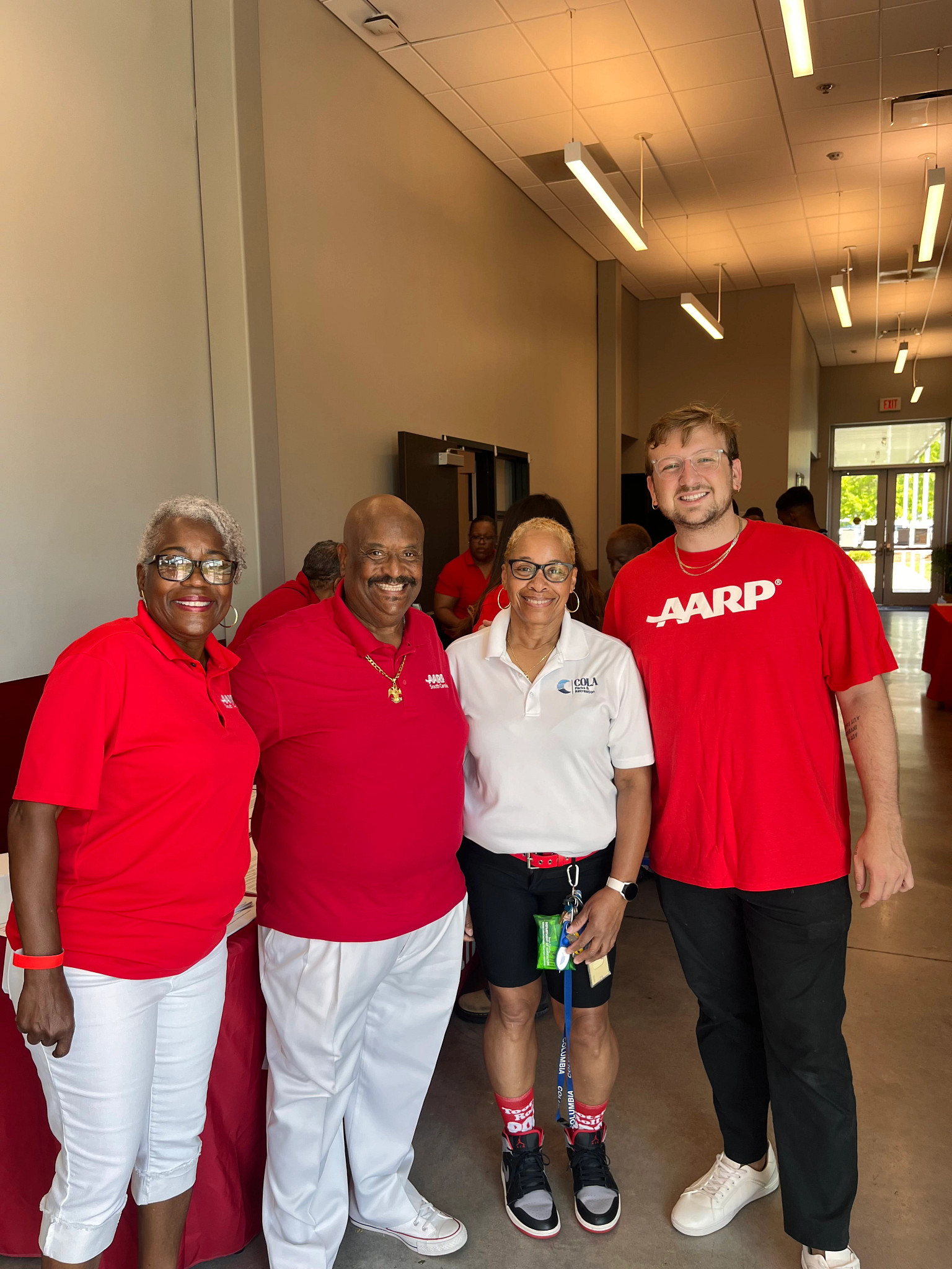 a group of four people smiling for a photo at an andrus award community service event