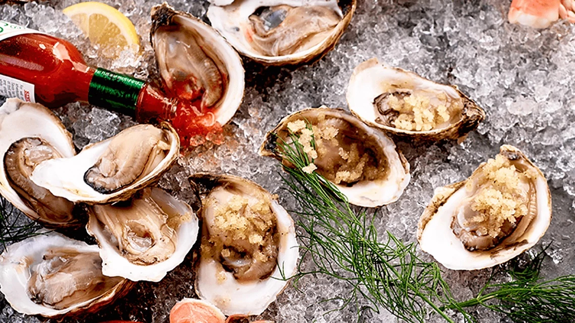 McCormick & Schmick's multiple oysters open and on ice with bottle tabasco sauce