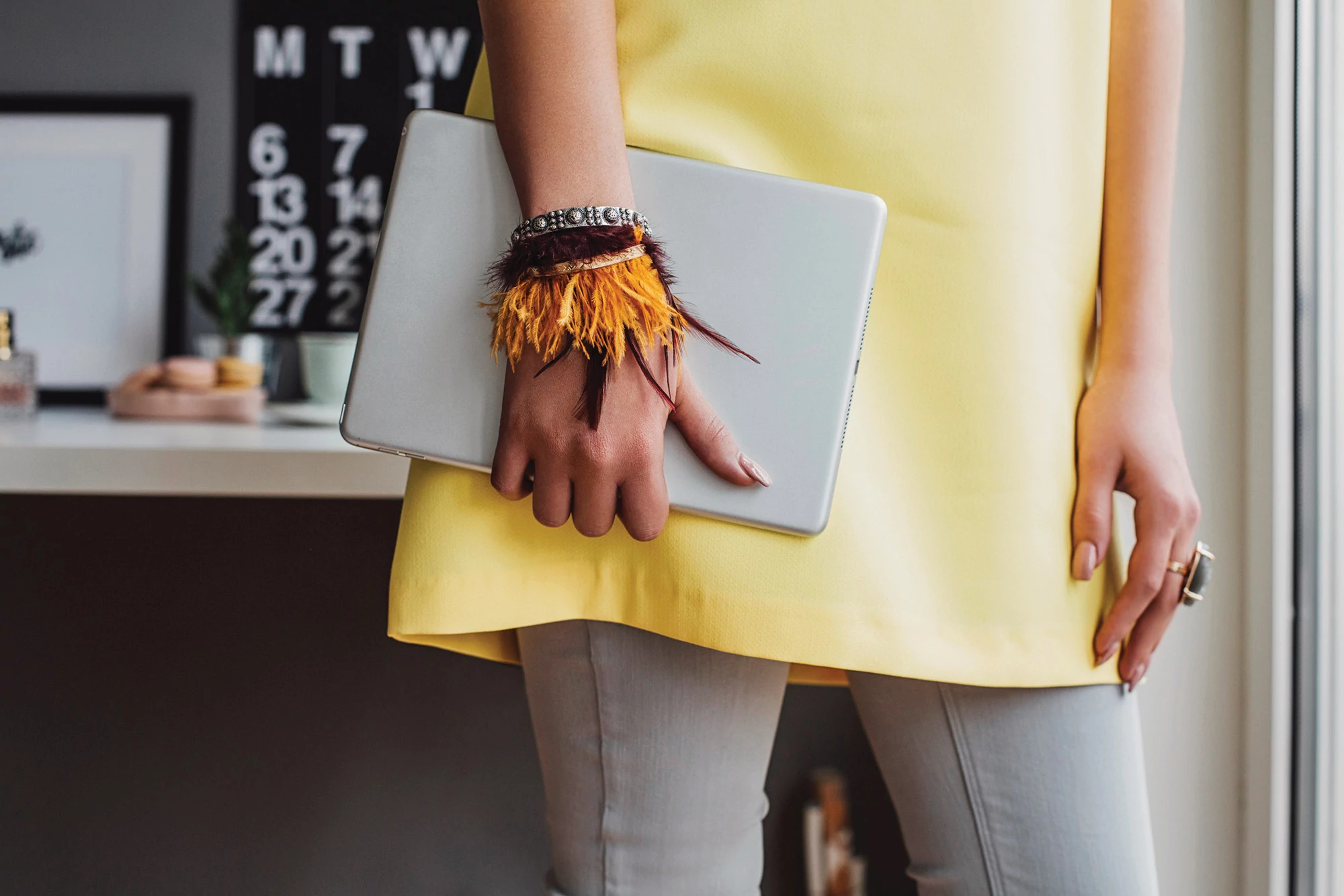 woman holding a tablet so she can take online courses at home