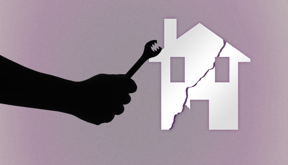 The shadow of a hand holding a wrench is hovering over a cracked home image on a purple background.