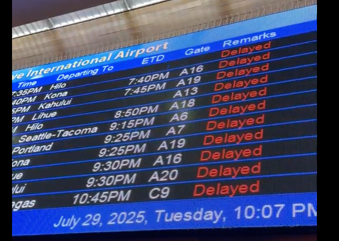 A screen at an airport showing a handful of flights delayed