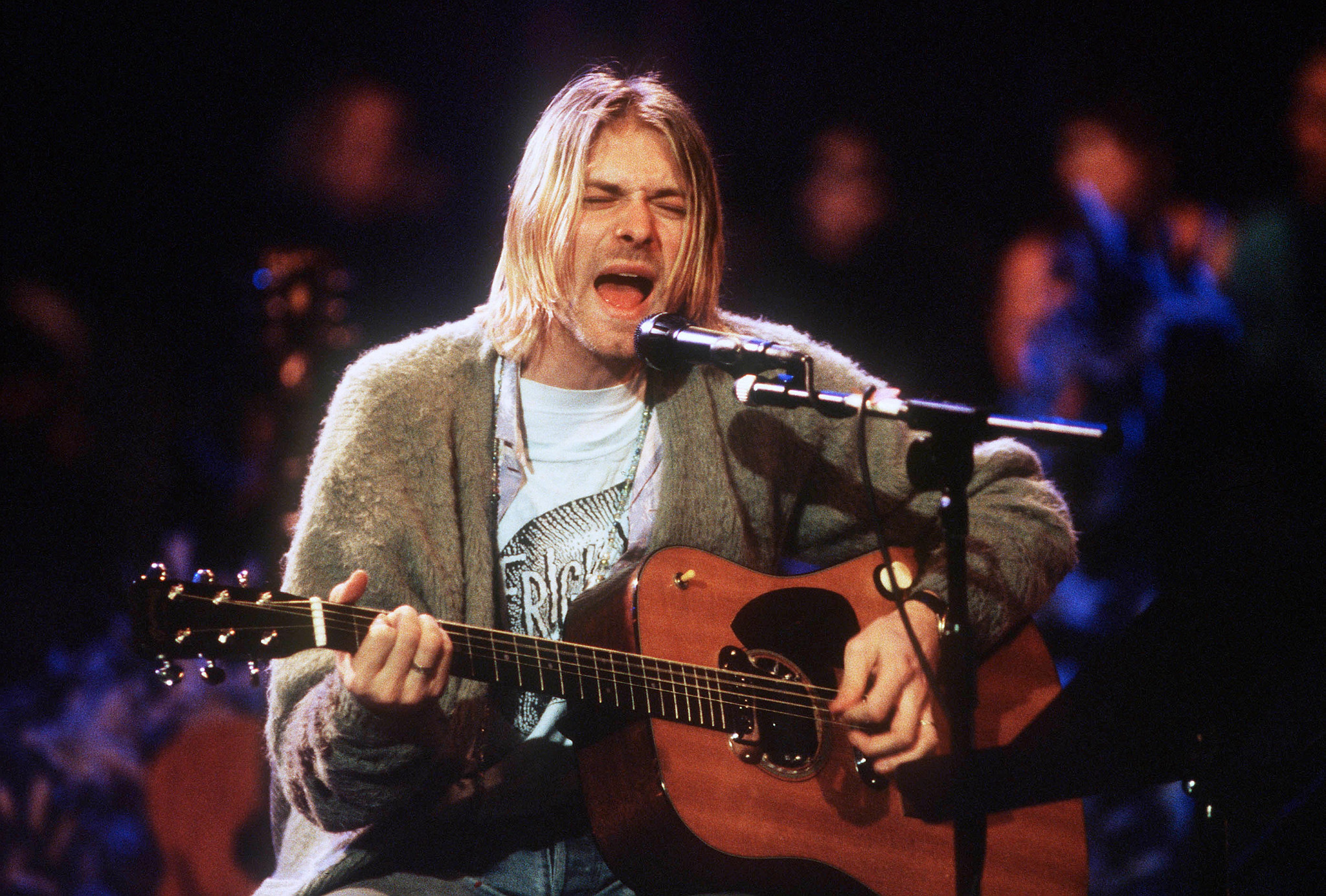 a photo shows Kurt Cobain from Nirvana performing on MTV’s Unplugged
