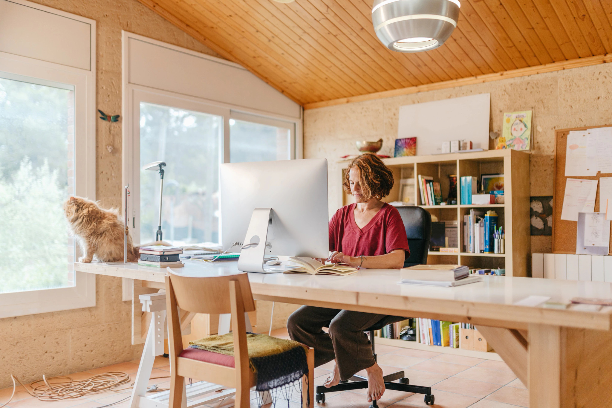 Woman working on her computer at her home office.