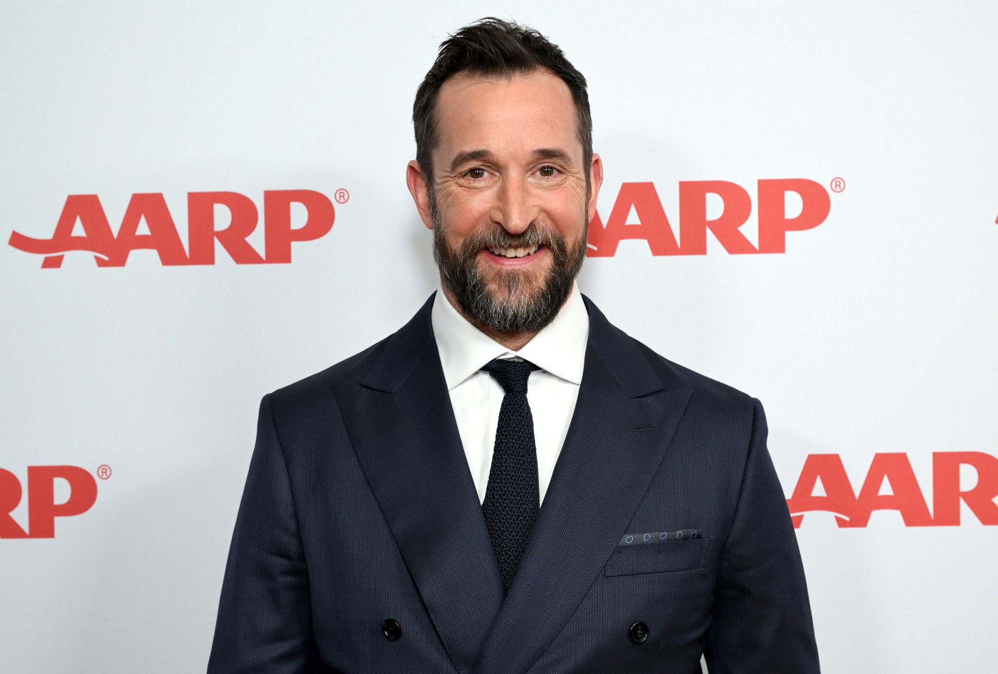 Noah Wyle smiling at an AARP event