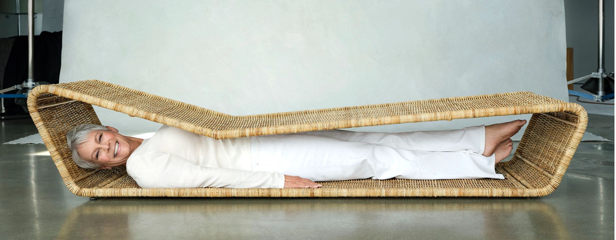 The Liberation of Jamie Lee Curtis jaime lee curtis lying inside of a low wicker chaise longue