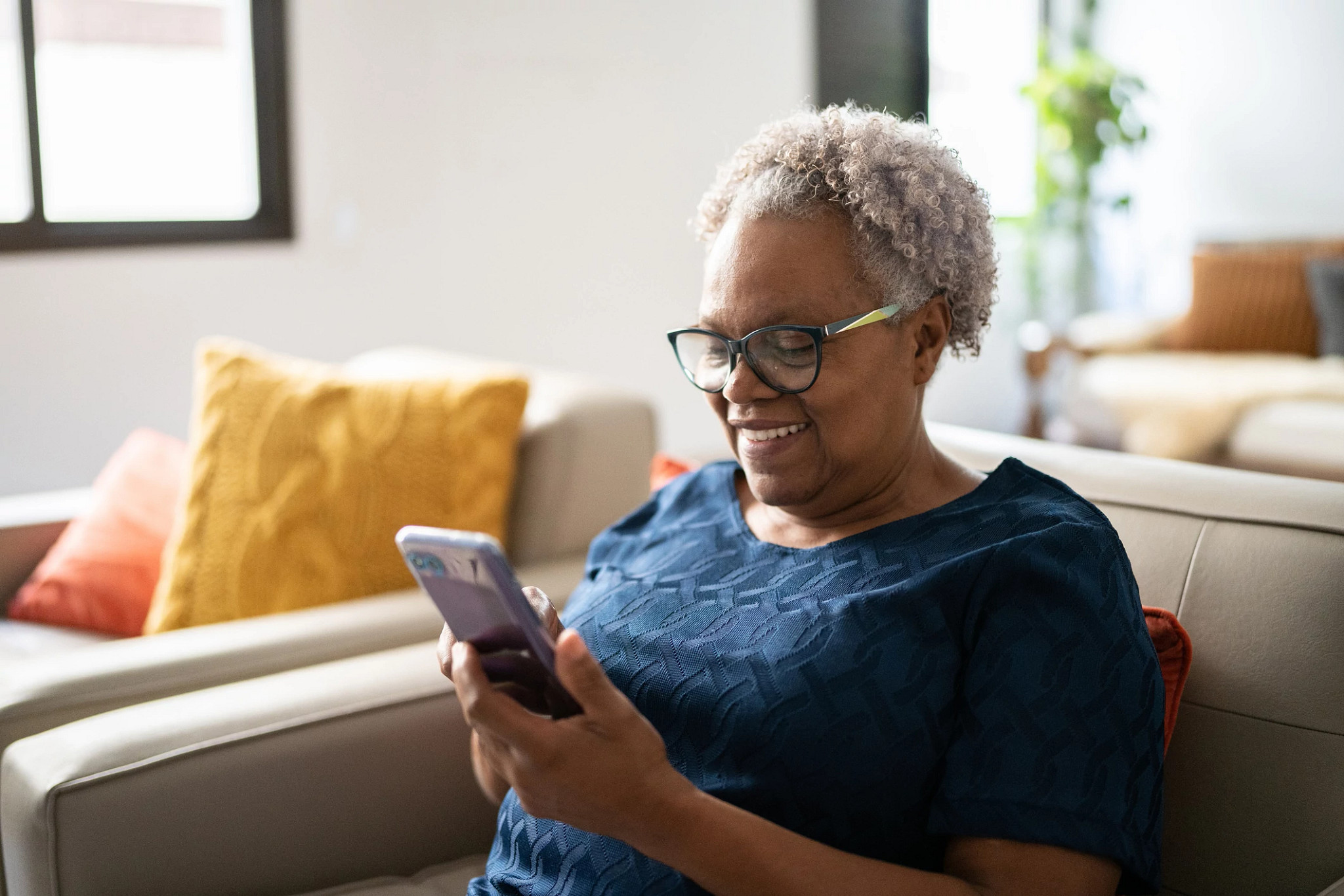 Senior woman using a mobile phone at home