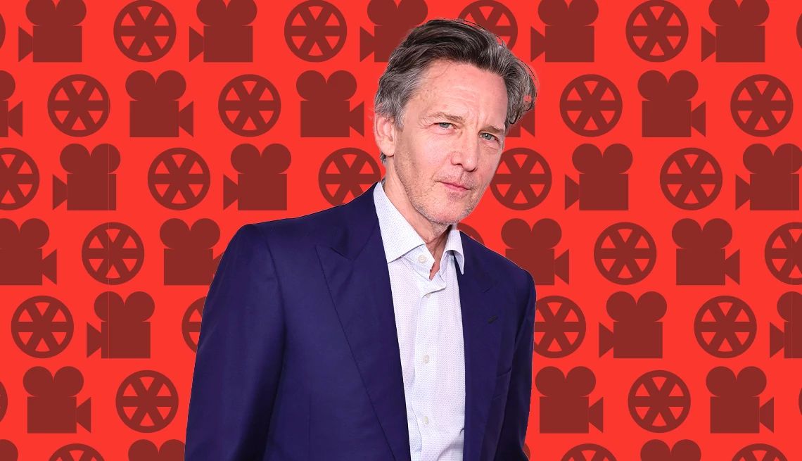 Andrew McCarthy interview Andrew McCarthy against red background with outlines of old film projector and wheels on it