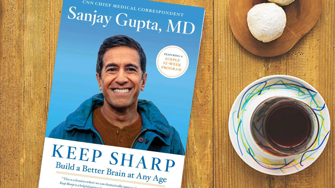 Keep Sharp: Build a Better Brain at Any Age Book Dr. Sanjay Gupta keep sharp book cover on wood table cup coffee