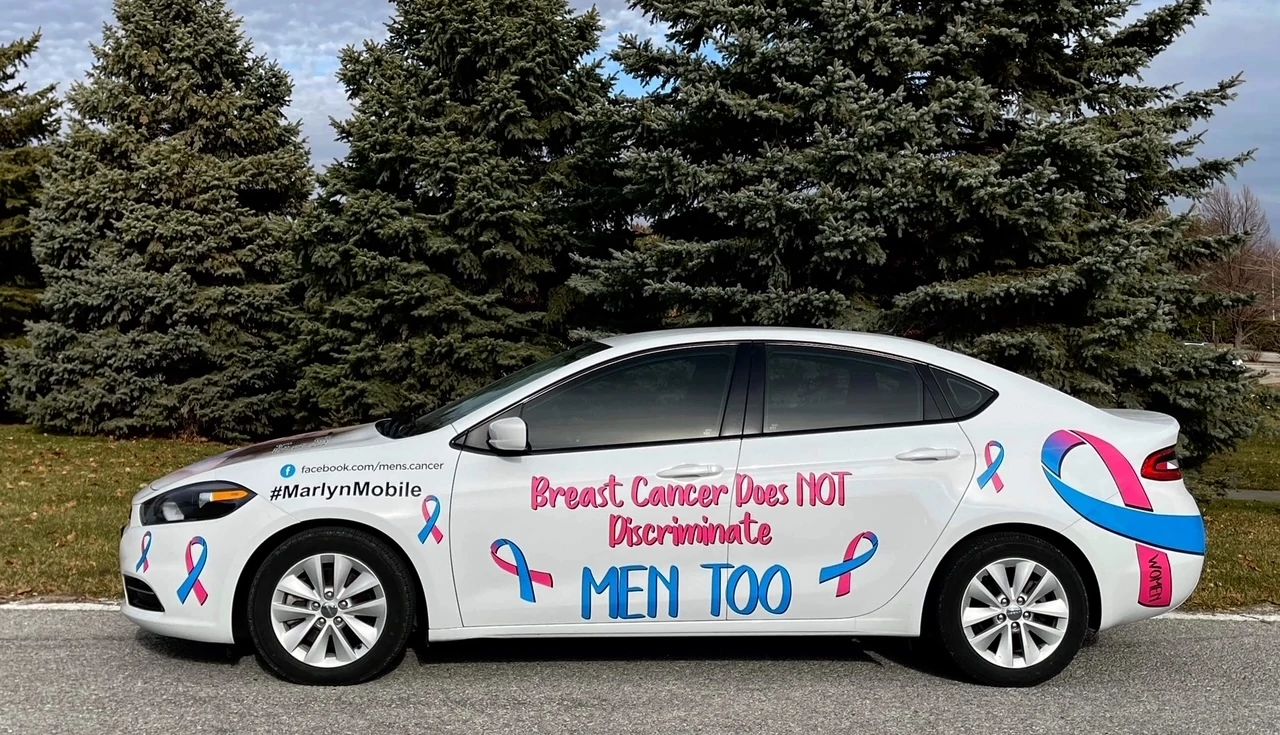 Breast cancer caregiving a white sedan with the words, breast cancer does not discriminate, men too