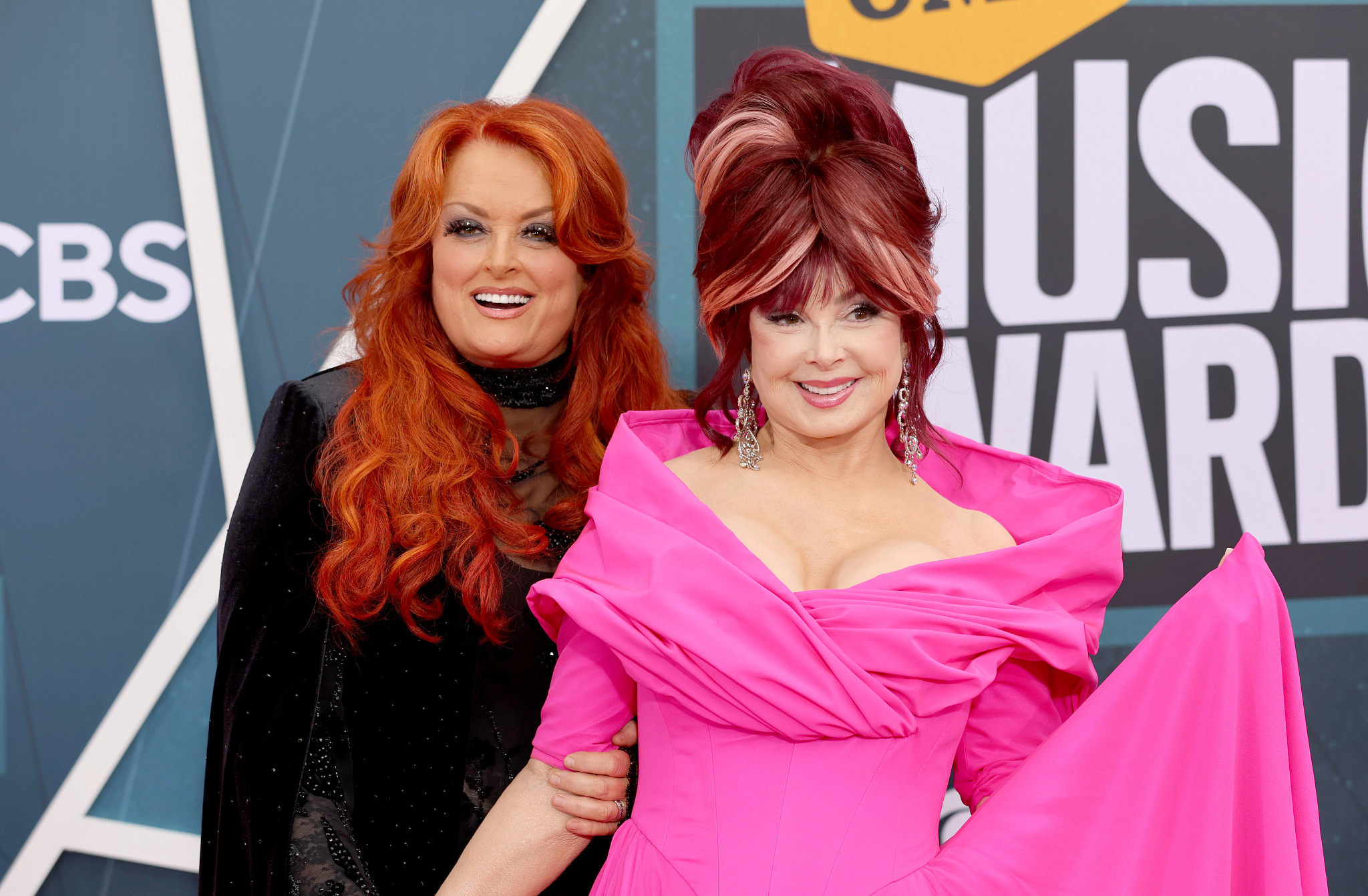 Wynonna Judd and Naomi Judd posing together.