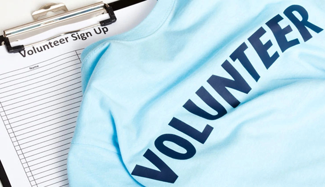 volunteer word on blue t-shirt and sign up clip board 