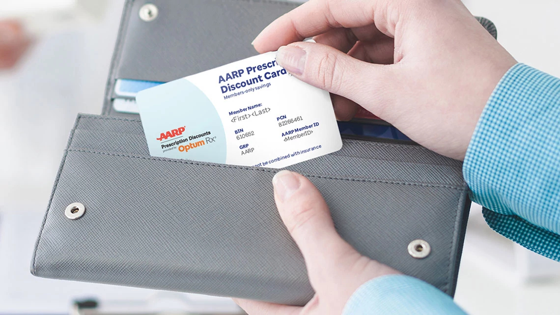 Woman buying products in the pharmacy pulling medical card out of gray wallet