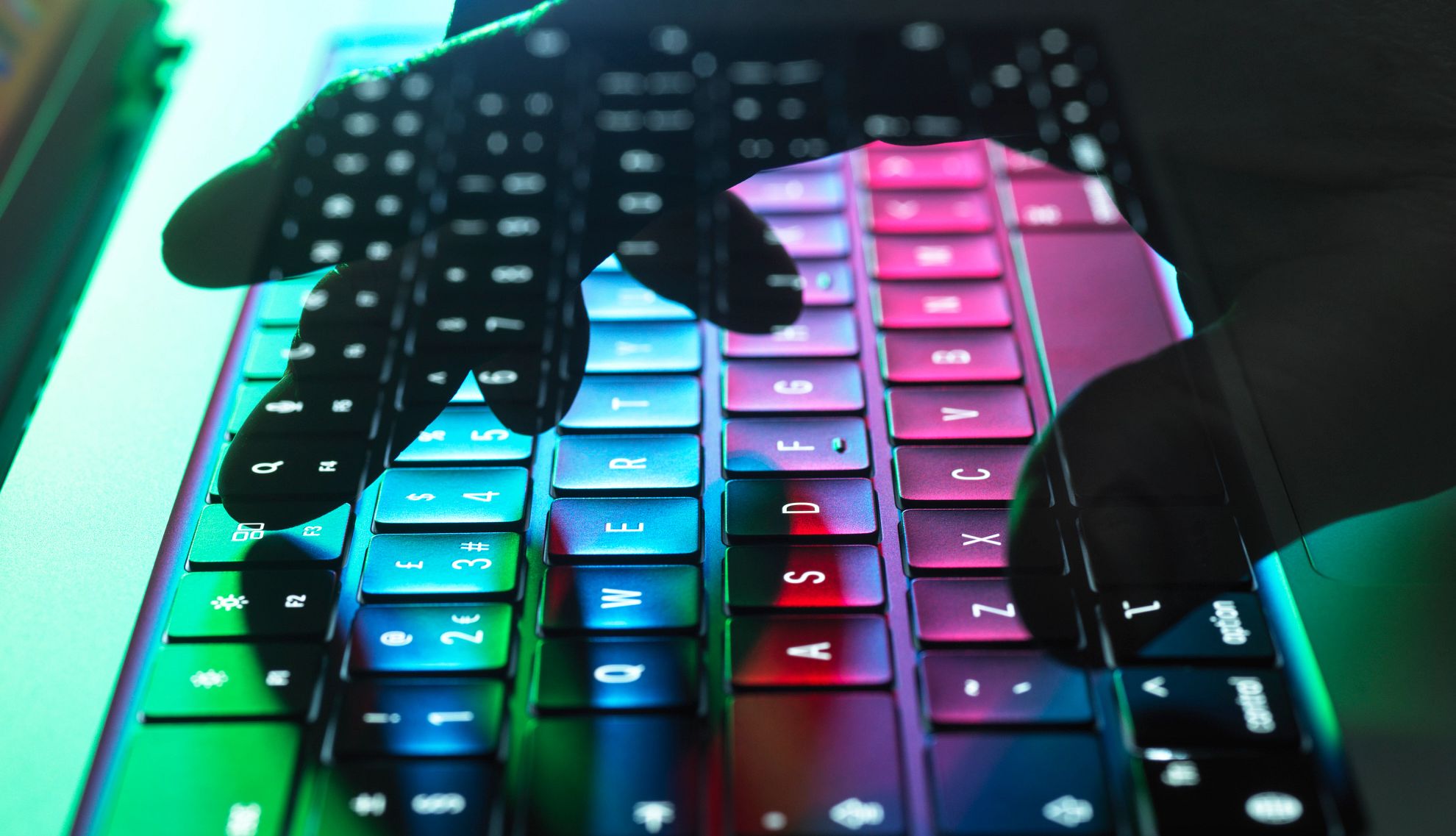 Un teclado con una mano sobre él con diferentes colores Un teclado con una mano sobre él con diferentes colores