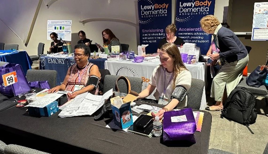 Participants at the Alter Dementia Summit learned to take their blood pressure Participants at the 2025 Alter Dementia Summit sitting at a table and using blood pressure monitoring cuffs