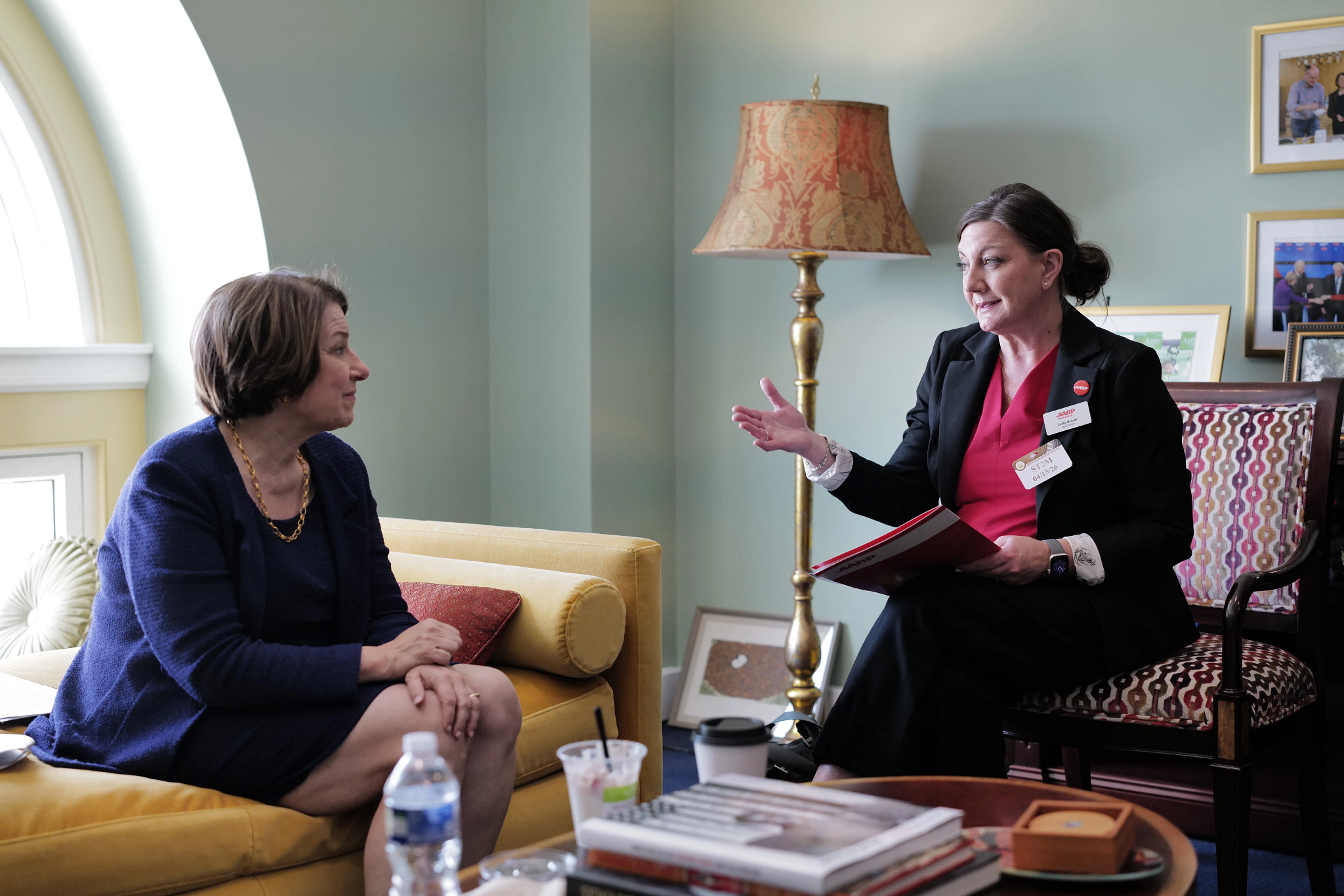 Cathy McLeer, state director for AARP Minnesota (at right), speaks with Sen. Amy Klobuchar (D-MN).