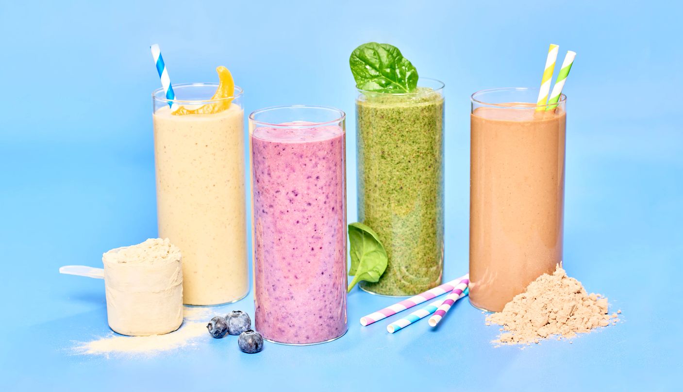 a collection of protein smoothies against a blue background