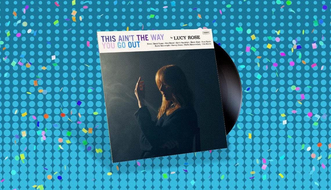 Album cover with record sticking out of it and the words This Ain’t The Way You Go Out with woman on cover; blue background with confetti on it