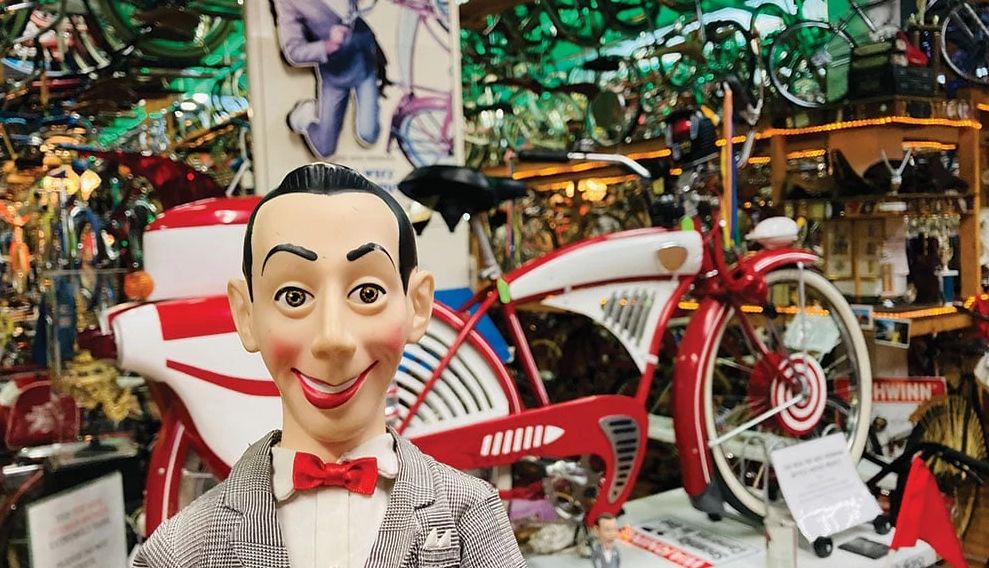 Pee-wee's Big Adventure Turns 40 a Pee-wee Herman figurine in front of his iconic red bike
