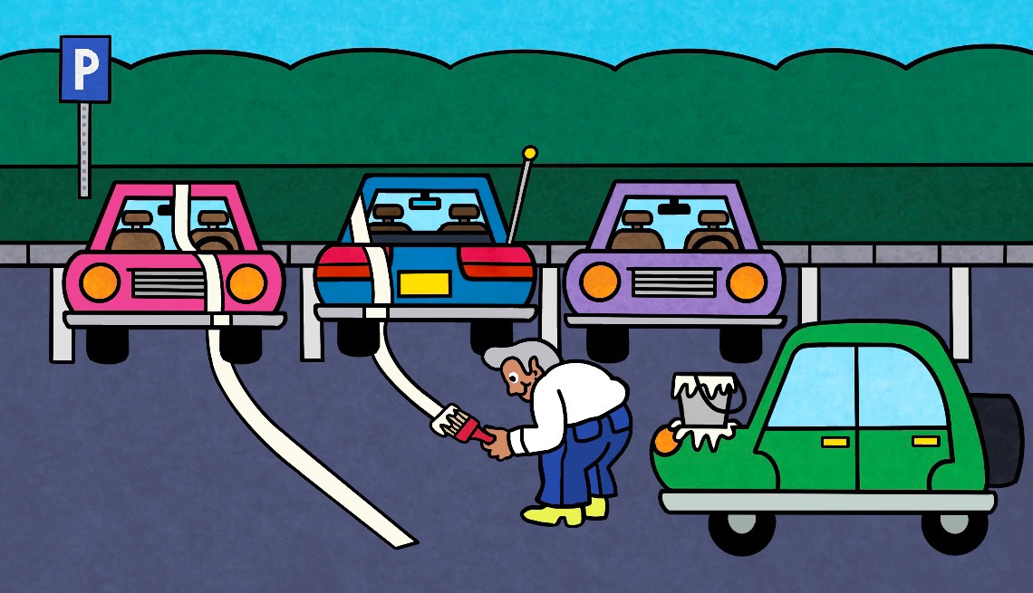 a person repaints lines in a parking lot