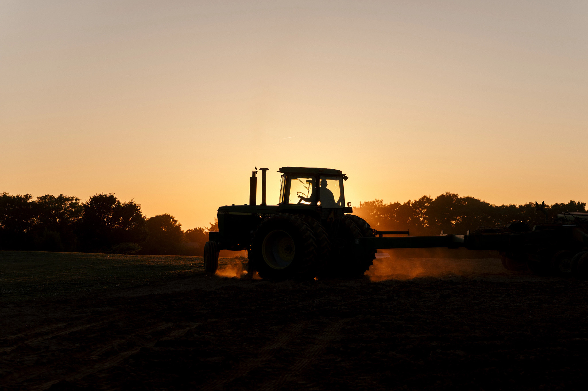 a person driving a tractor