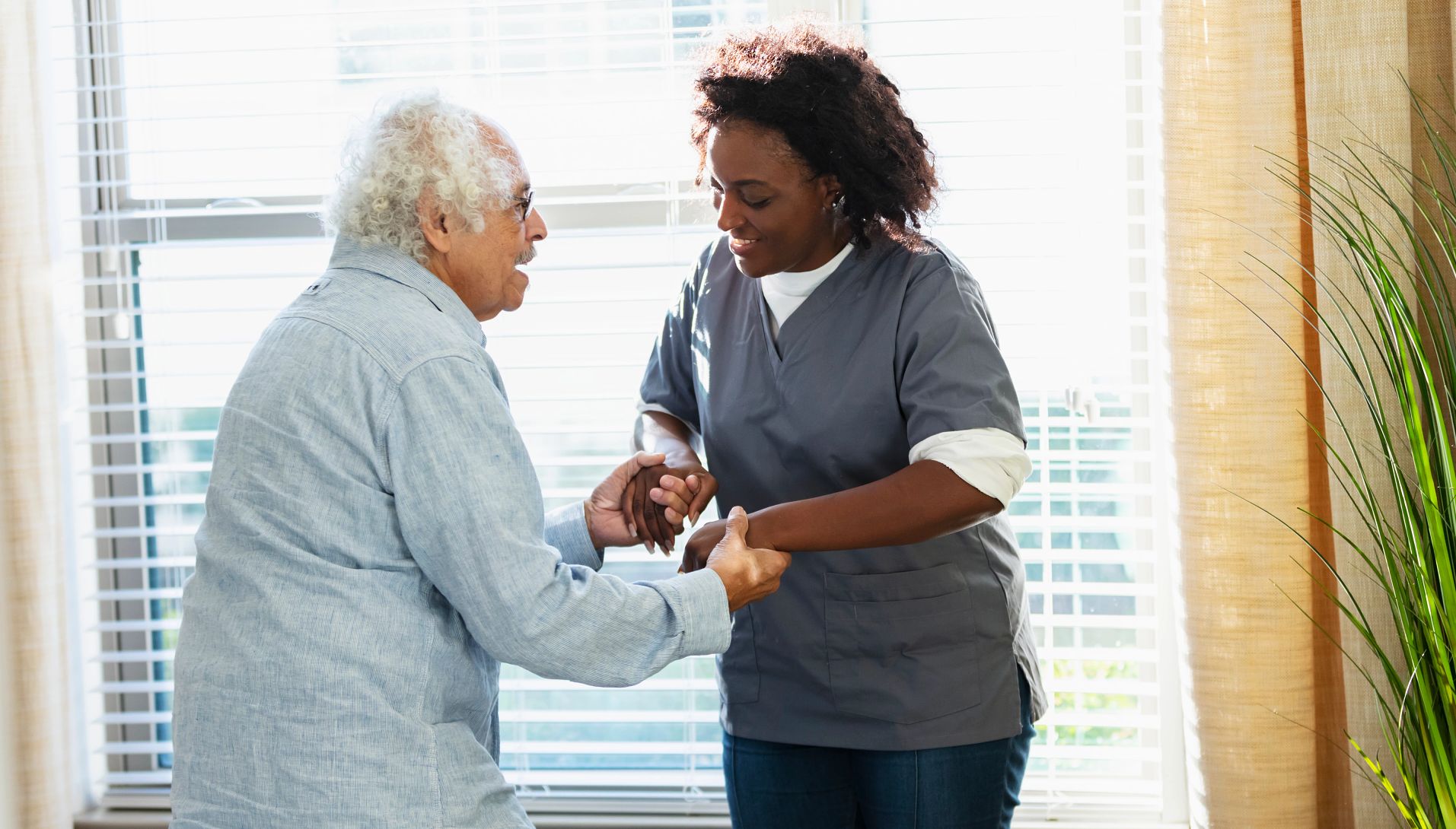 a health care worker listens to a patient's chest through a stethoscope