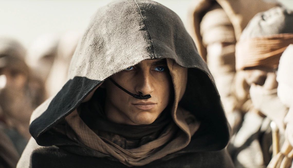A close up of Timothée Chalamet in a hooded cloak in "Dune: Part Two." A close up of Timothée Chalamet in a hooded cloak in "Dune: Part Two."