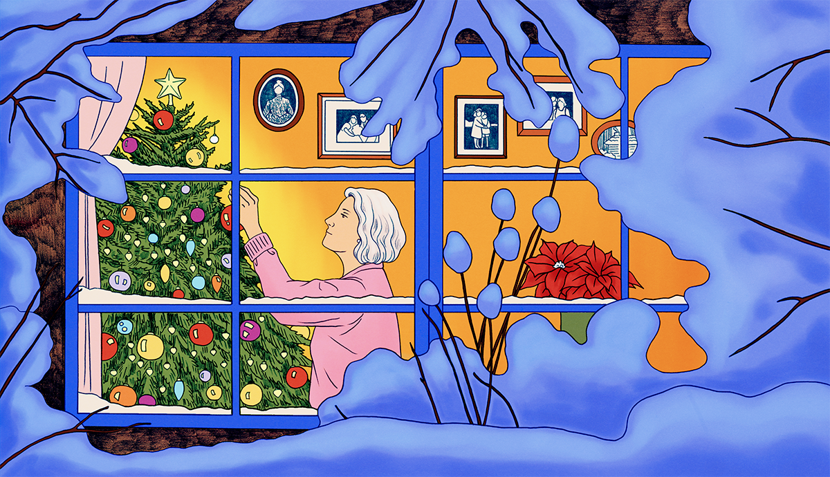 An older adult decorating a holiday tree indoors during winter, viewed through a snow-covered window.