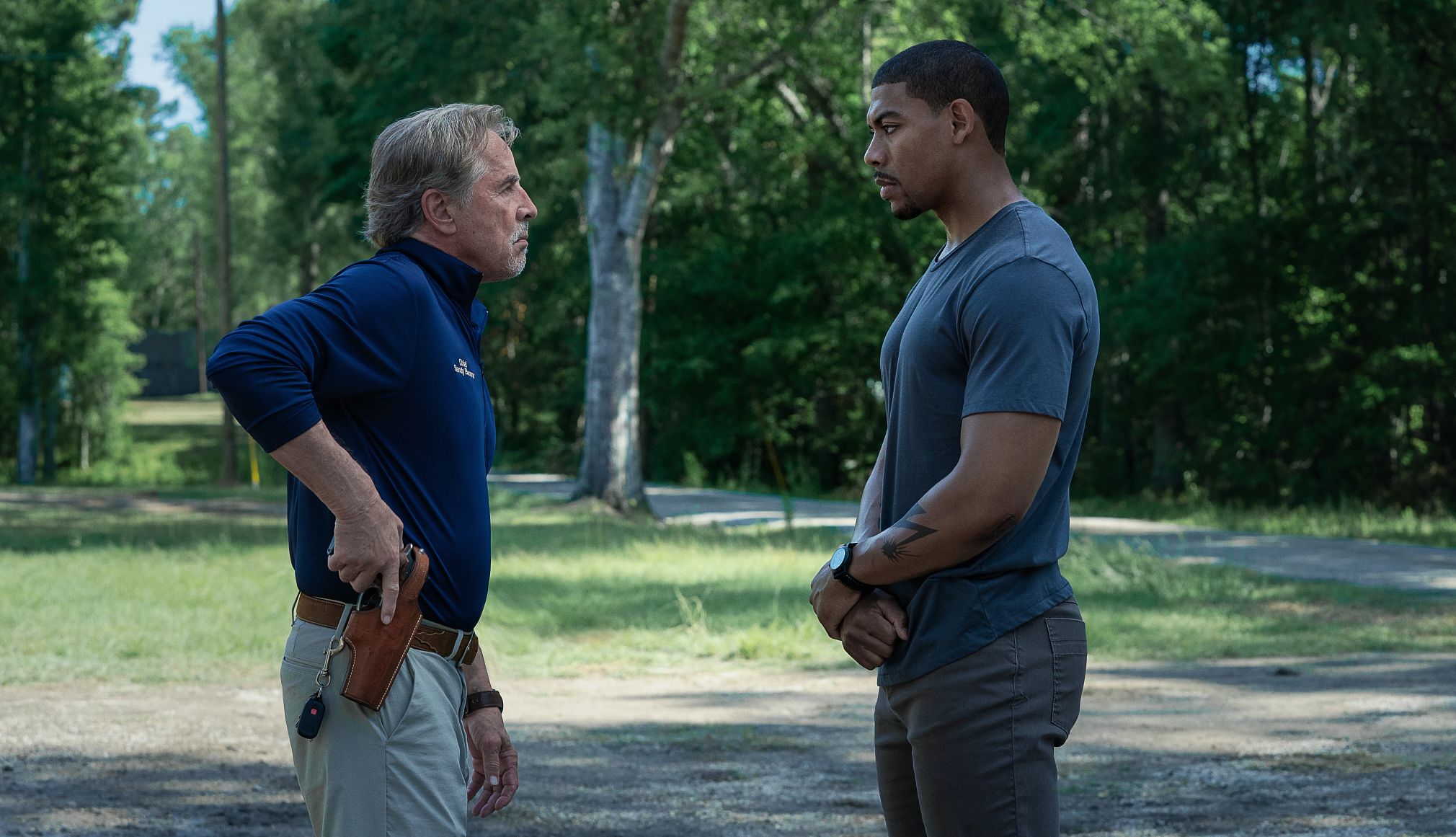 Don Johnson and Aaron Pierre in Rebel Ridge Don Johnson holding his gun in his holster looking at Aaron Pierre in the Netflix film Rebel Ridge