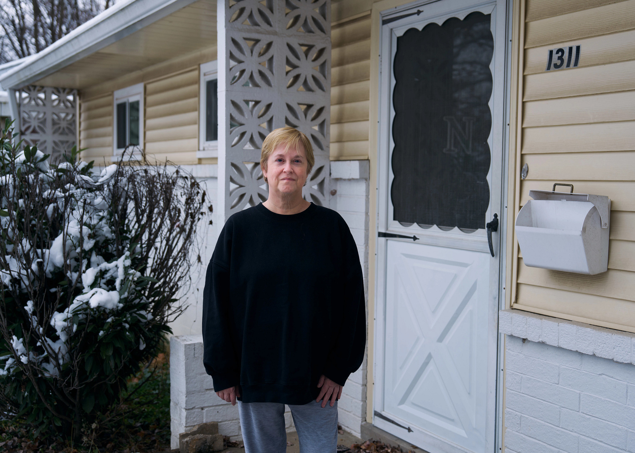 a person standing outside of their house