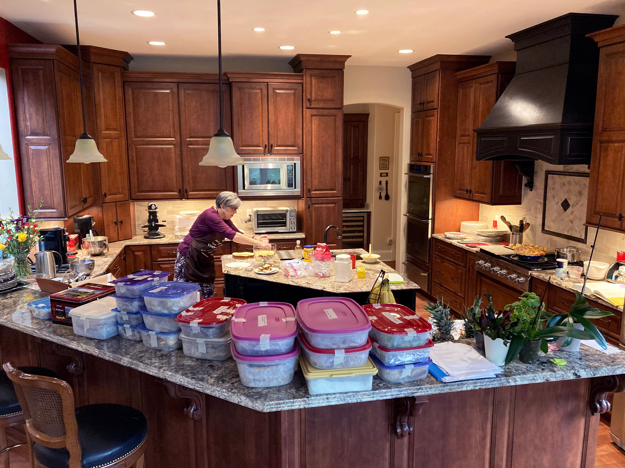Barbara Beckerman preparing baked goods in a kitchen with various dishes in tupperware on the counter