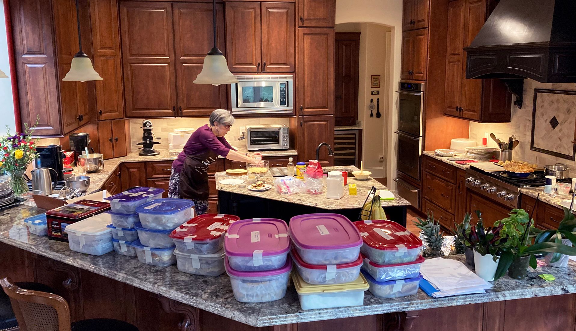 Barbara Beckerman preparing baked goods in a kitchen with various dishes in tupperware on the counter