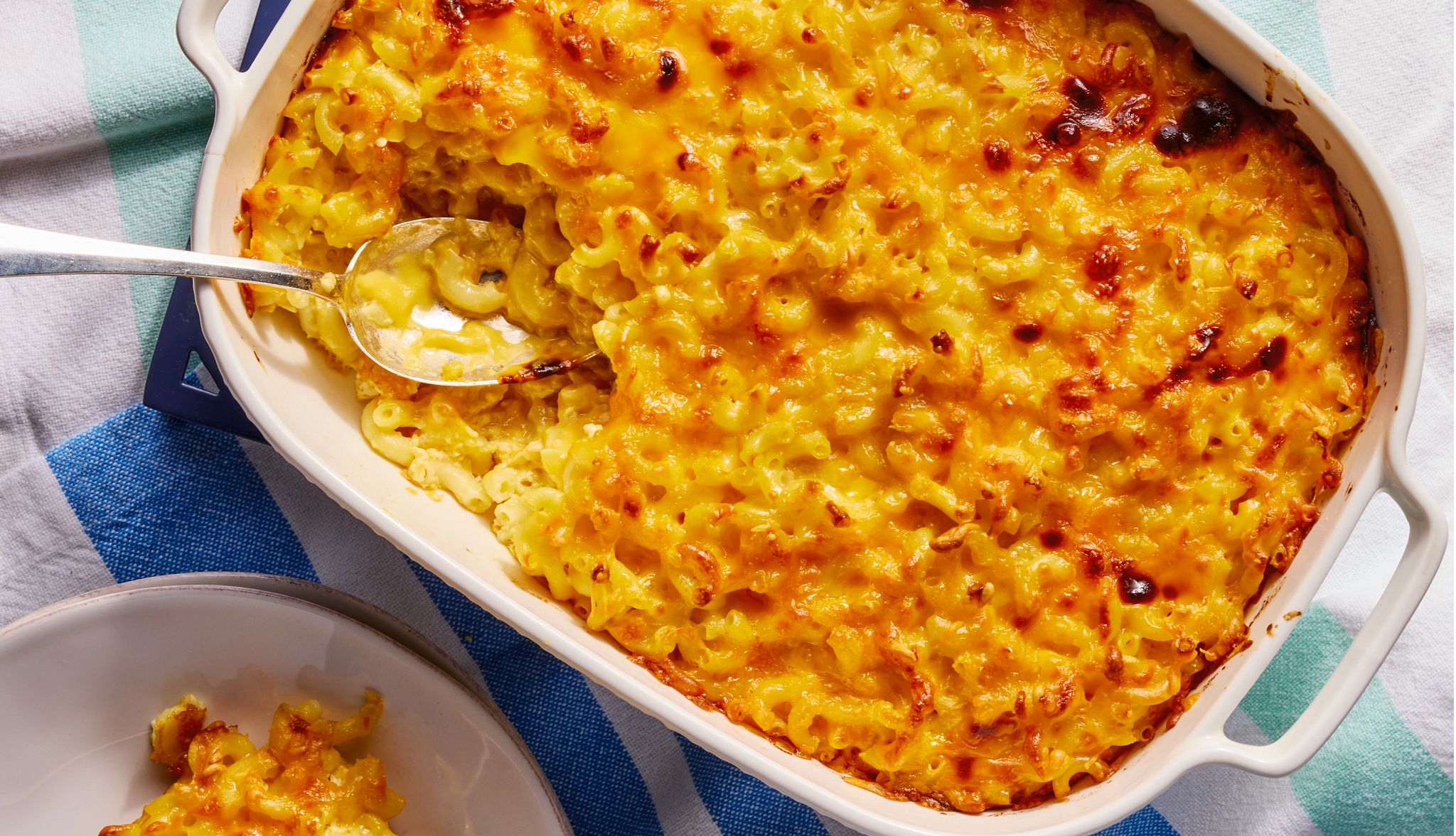 craig melvin mac and cheese a pan of macaroni and cheese with a spoon next to a plate