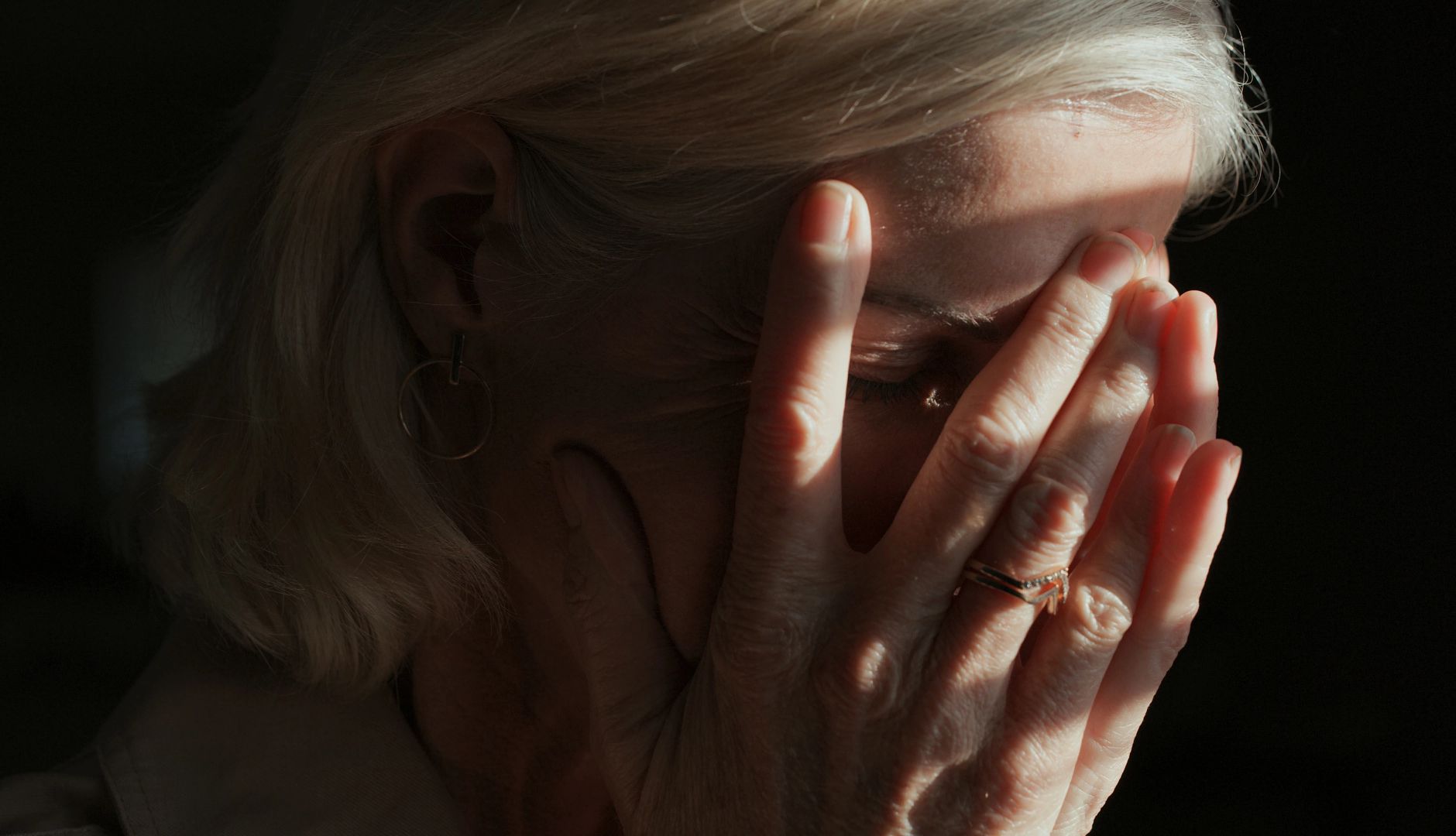 Could You Have Photophobia? a person with their head in their hands