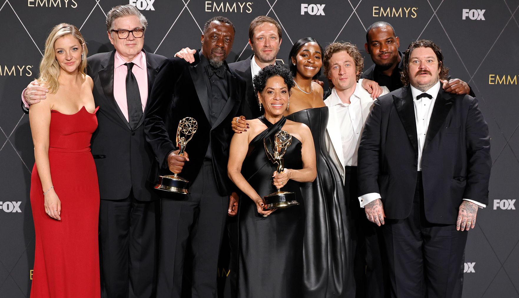 Platt and his fellow cast members celebrated "The Bear" winning an Emmy for outstanding comedy series at the January 2024 ceremony in Los Angeles Oliver Platt and fellow cast members holding Emmy statuettes in front of Emmys and Fox backdrop