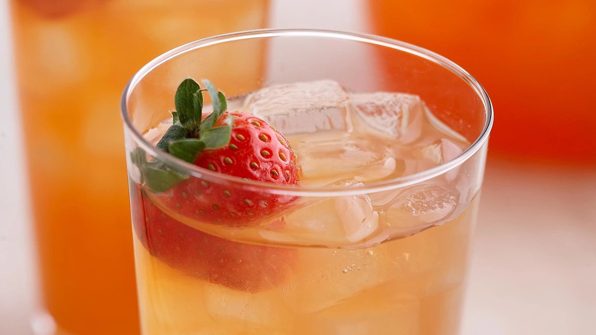 A close-up view of a strawberry iced tea in a glass