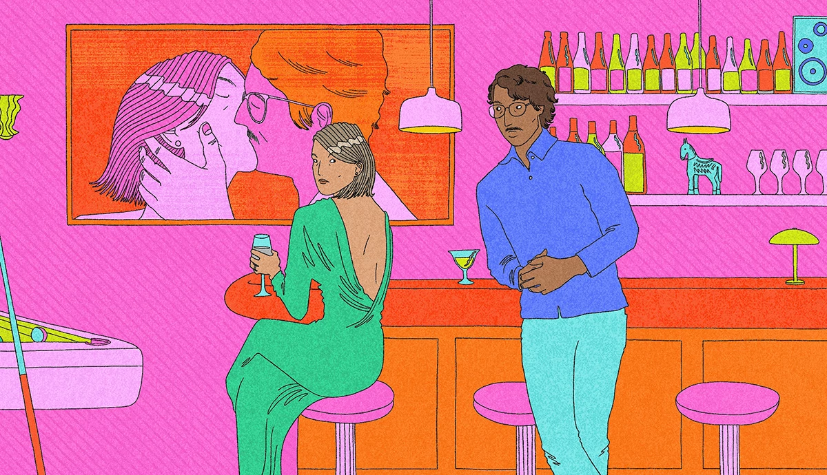 A woman sits on a bar stool holding a drink while a man stands nearby in a modern bar.