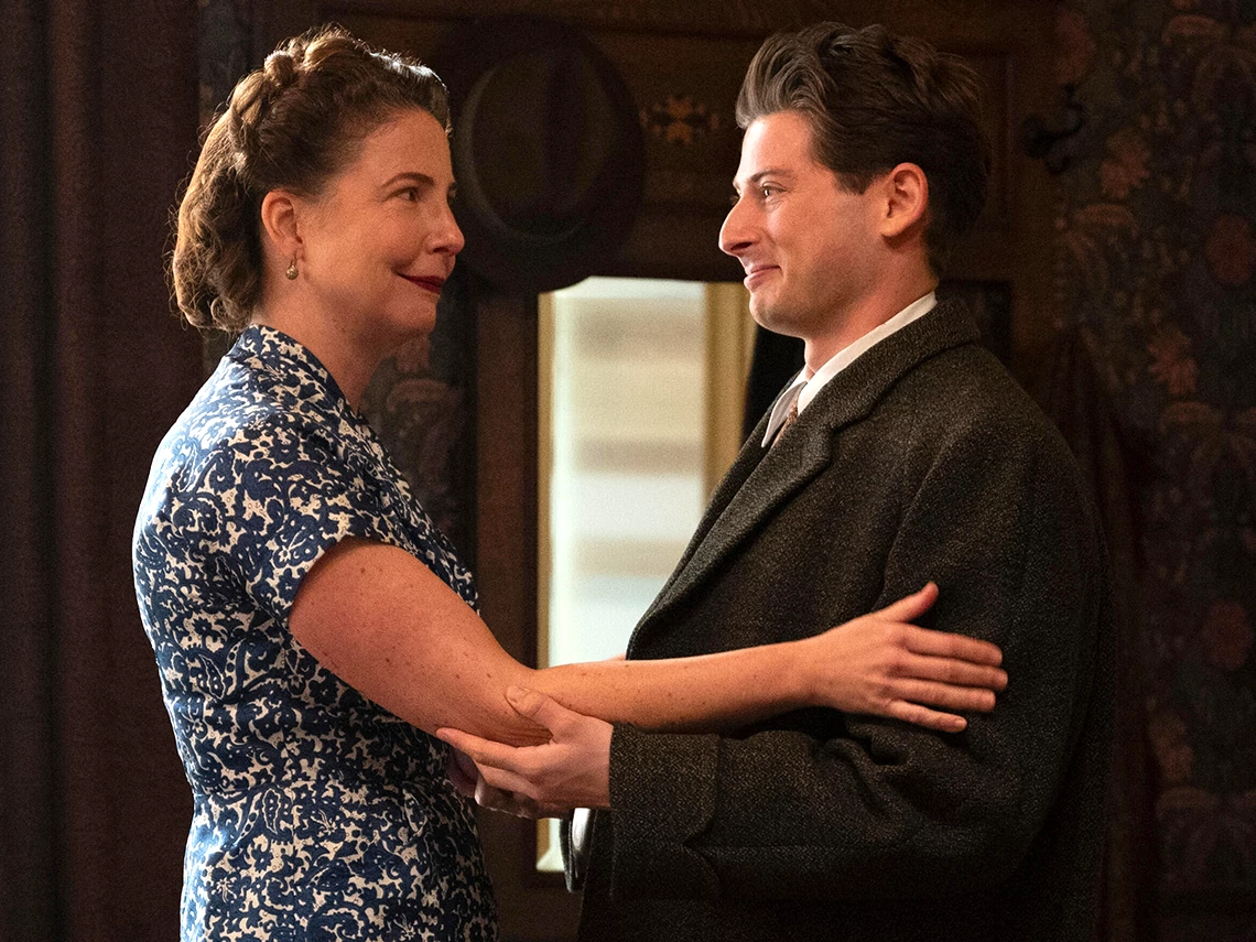 Robin Weigert and Amit Rahav  in We Were the Lucky Ones Robin Weigert and Amit Rahav looking at each other while embracing each other by the arms in We Were the Lucky Ones
