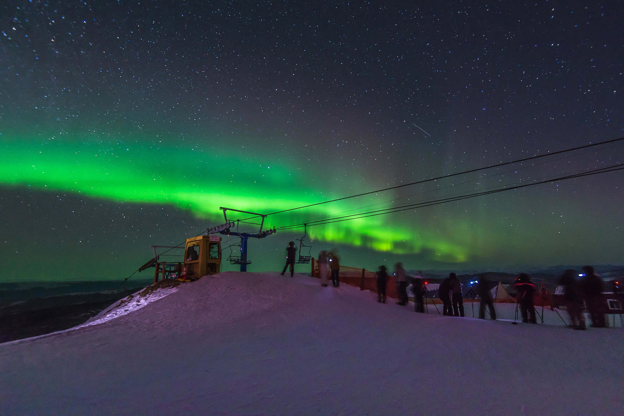 Daytime activities snowmobiling and snowshoeing Aurora borealis, dancing over Fairbank, Alaska