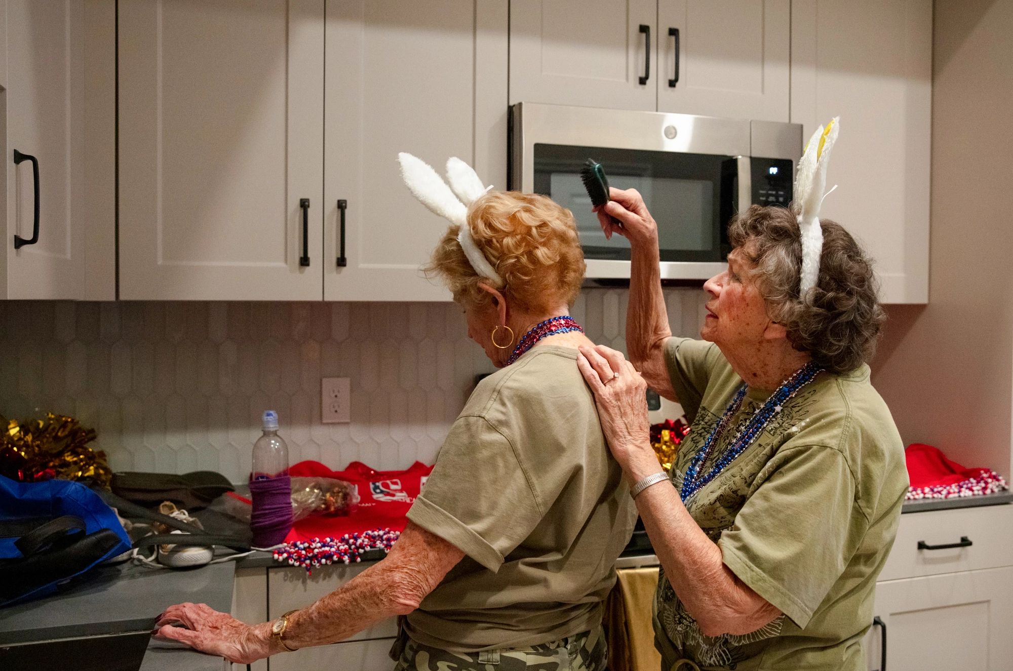 Best AARP Photos of 2024 a woman brushing another woman's head