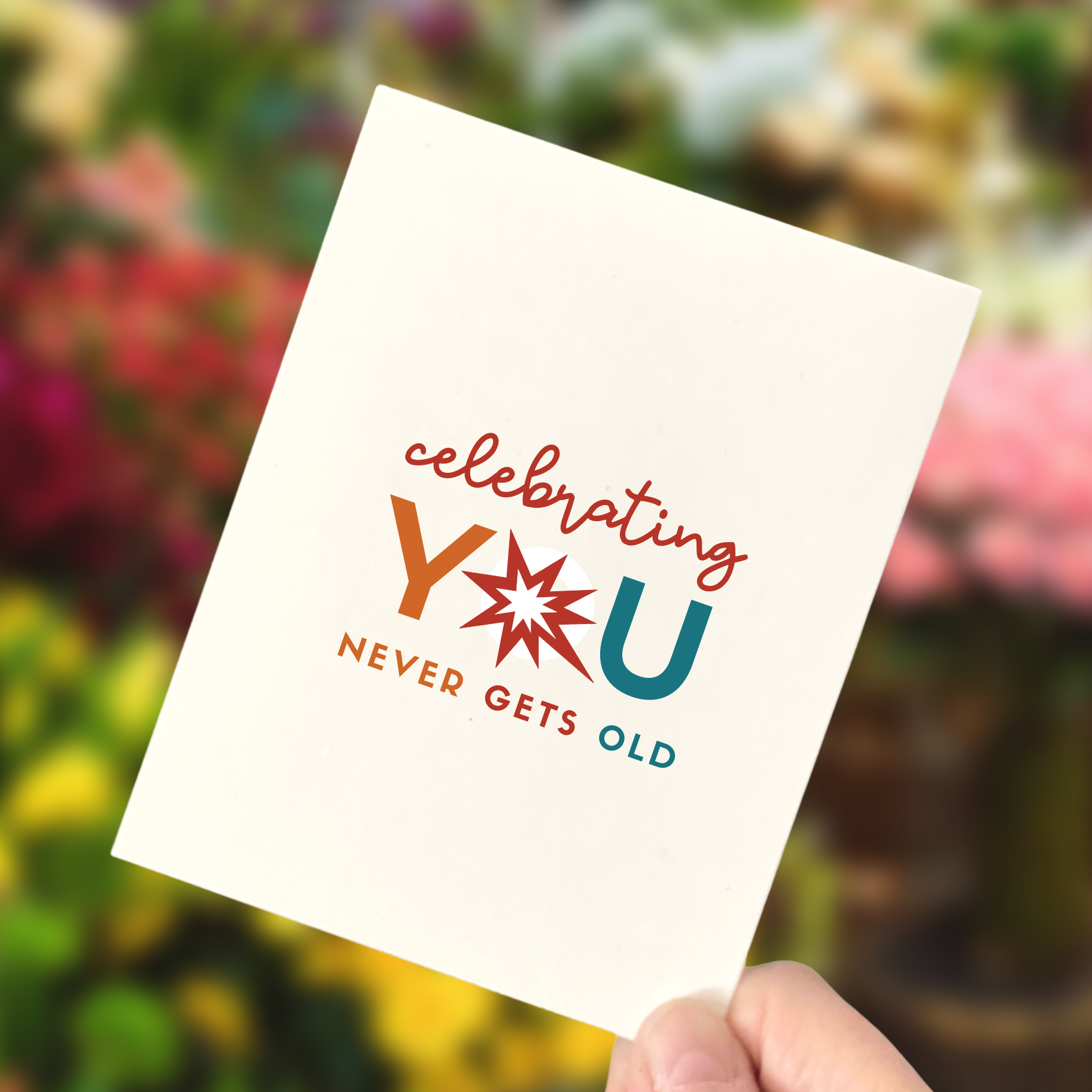 person holding a birthday card that says Celebrating you never gets old