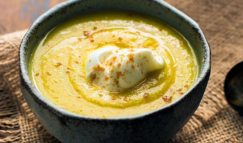 A close-up view of curried parsnip and apple soup in a bowl