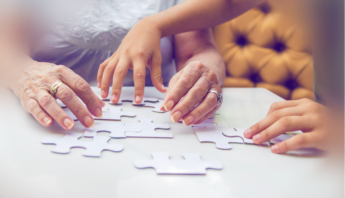 Some thinking skills may slow as you age The hands of a woman working on a jigsaw puzzle