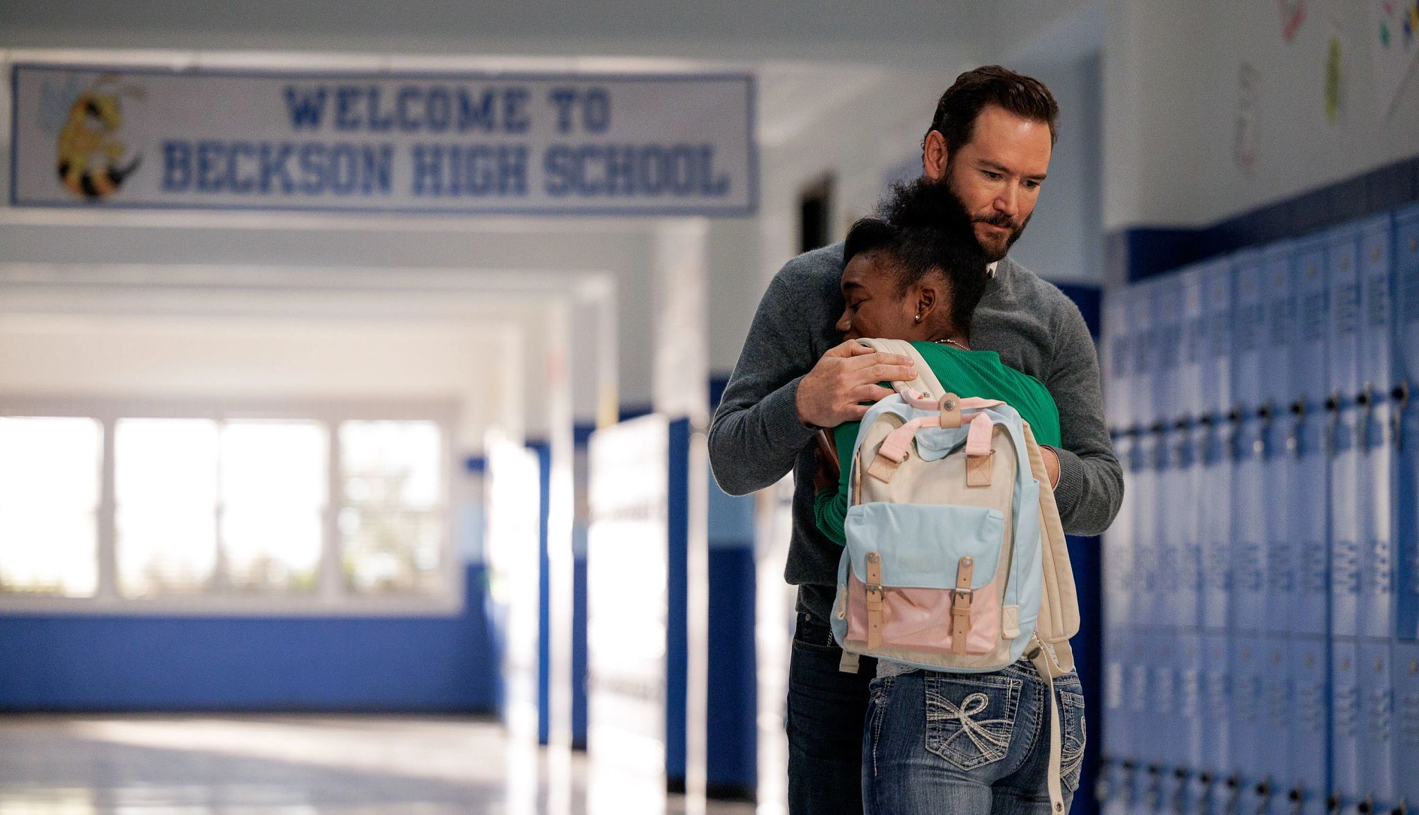 Mark-Paul Gosselaar stars in 'Found' Mark-Paul Gosselaar hugging A'Zaria Carter in hallway of school; sign that says Welcome to Beckson High School is in background in a still from Found