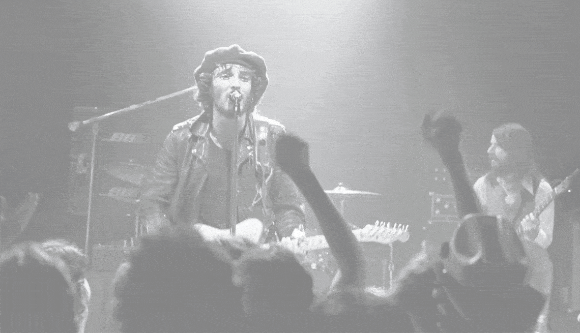pop culture concert 1975 black and white image of bruce springsteen on stage
