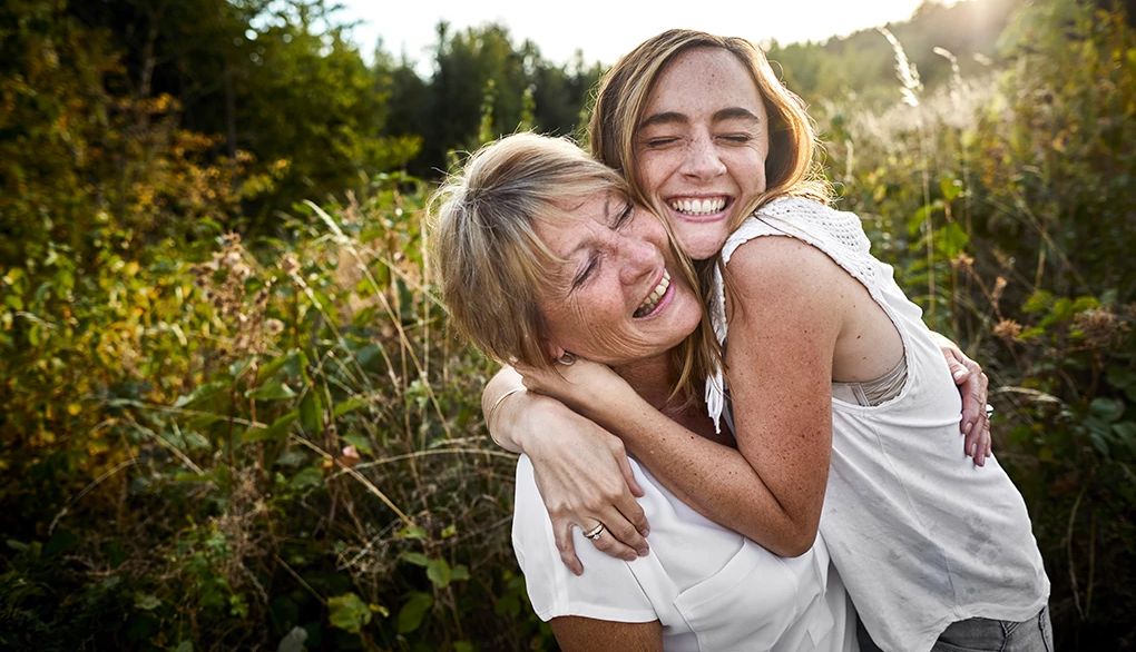 Sending and receiving kindness and compassion can be good for you A mother and daughter hugging in the countryside