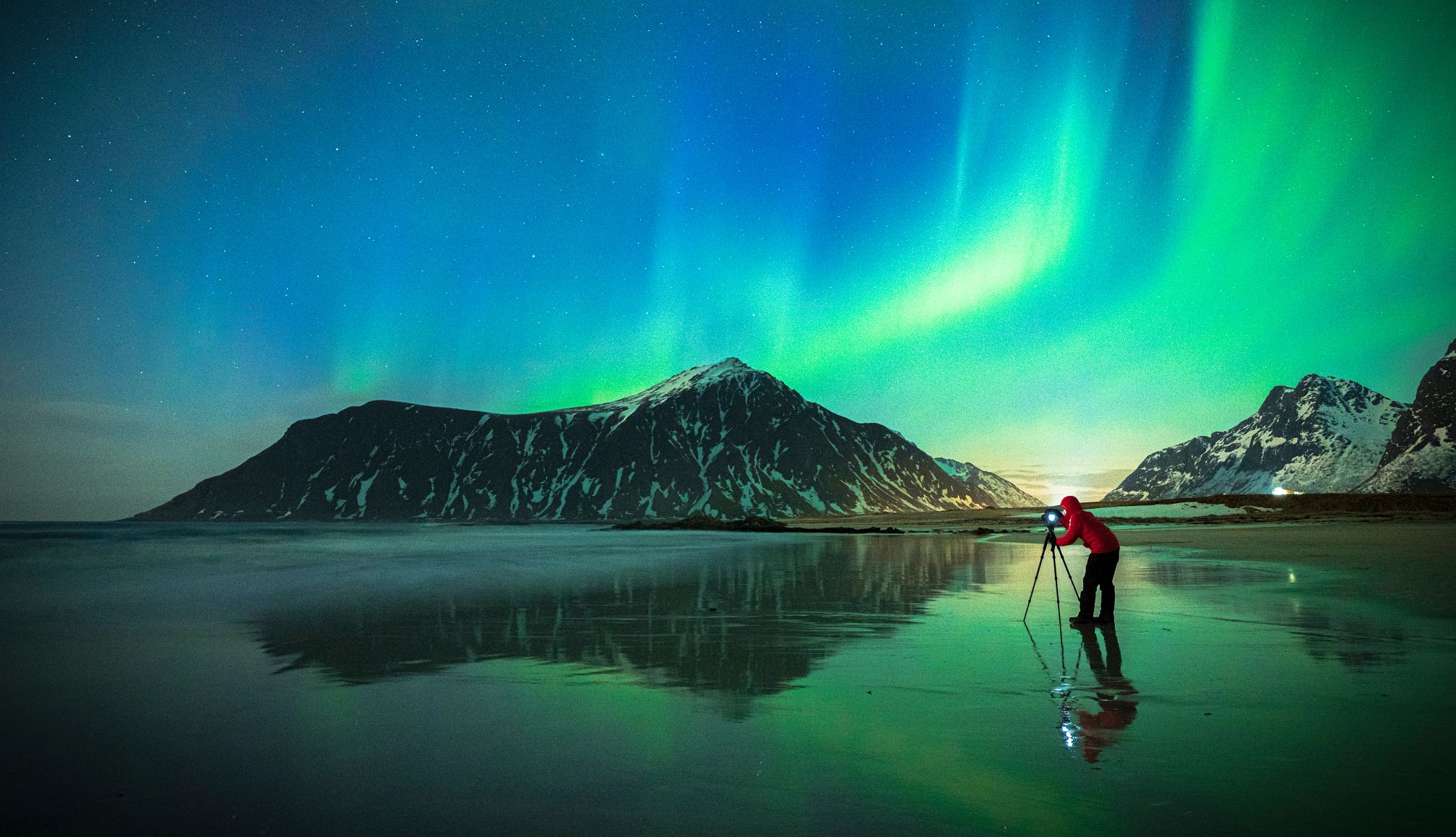 Photograph the Northern Lights a person taking a picture of the northern lights